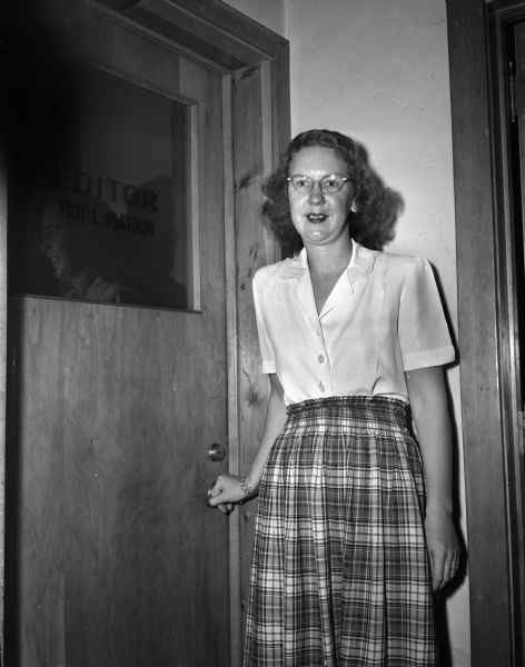 Hildur Hanson, secretary to <i>Wisconsin State Journal</i> Editor Roy Matson, standing in front of the door to his office.