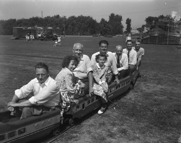 Madison Labor officials riding on a tiny train at the 6-day Labor Festival at Olbrich Park.