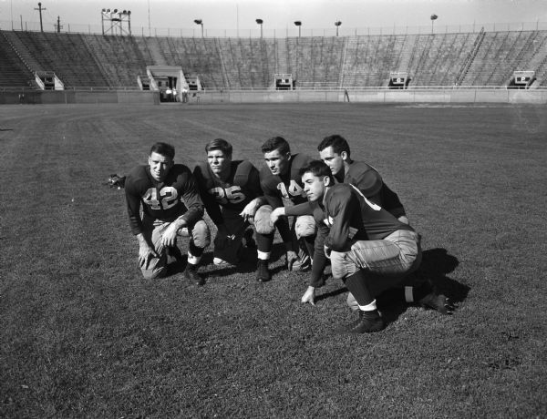 Five University of Wisconsin football players posed in Camp Randall Stadium.