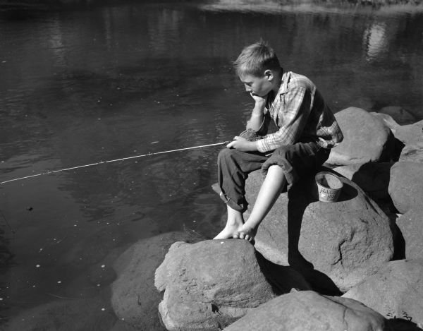 David Bickel, 414 Clemons Avenue, fishing on the shore of Tenney Park lagoon.