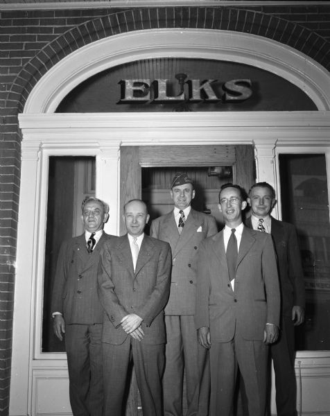 Five men standing in front of the entrance to the Elks club at 120 Monona Avenue.