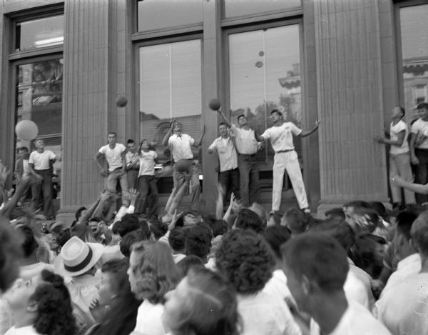 Crowd in front of the Union Trust Co. building, 1 West Main Street, during the balloon barrage in which balloons are being released with $2 merchandise coupons from Captitol Square stores.