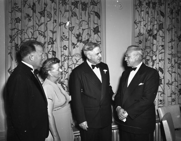 Four attendees at a dinner at the Hotel Loraine welcoming Dr. H. Clifford Northcott, the newly-elected bishop of the Methodist Wisconsin conference.  Pictured from left to right are: Ellis H. Dana, executive vice-president of the Wisconsin Council of Churches; Mrs. Florence Northcott; Bishop Northcott; and Governor Oscar Rennebohm.