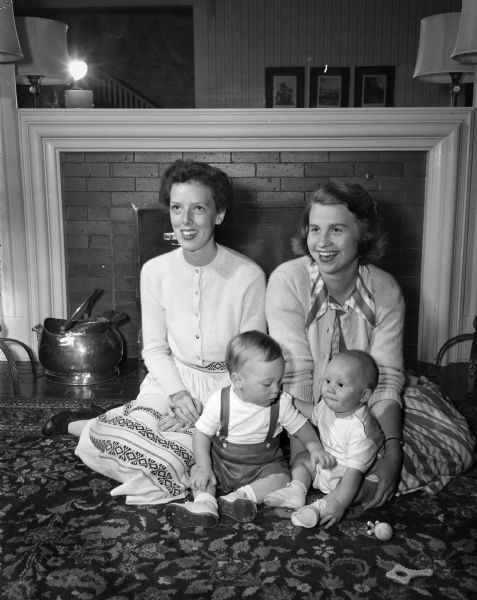 From the left is Caryl Kennedy Benish (Mrs. George A.), San Pedro, California, with her son Robert, visiting with her lifelong friend Jane Weston Johnson (Mrs. William E.), with her son David, at the home of Mrs. Benish's parents, 1220 Sherman Avenue.