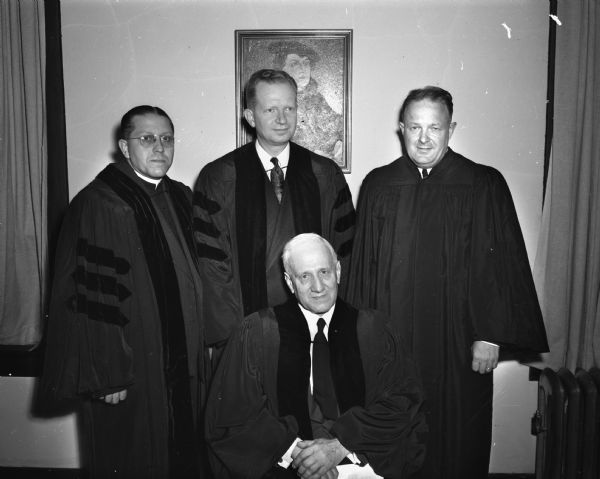Dr. E. Stanley Jones, a former bishop and missionary to India, seated with three Madison religious leaders standing behind him. He was in Madison to make a plea for a "united church" to members of Madison denominations.