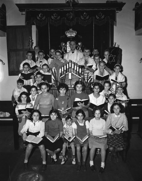 Group portrait of Rabbi Max A. Lipshitz and young students of the Madison Talmud Torah. The children are preparing to conduct their own junior congregation services to mark the beginning of the Jewish New Year at sunset on October 3 and other high holy days.