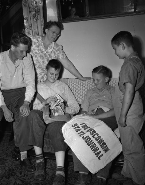 Mrs. Arthur E. (Florence) Schlimgen and four of her sons who are or were <i>Wisconsin State Journal</i> newspaper boys. Pictured from left to right are: Laurence, the family's first newsboy, now "retired"; Mrs. Schlimgen; Norbert; Edwin, the most recent family member to become a newsboy; and Bobby.