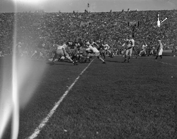 Bobby Petruska (44) shown carrying the ball as the University of Wisconsin beat Illinois 20 to 6 at Camp Randall Stadium. The other Wisconsin player in the picture is Ken Huxhold (70).