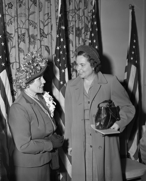 Miss Louise Marston, right, society editor of the <i>Wisconsin State Journal</i>, talking to Mrs. Earl Warren, wife of the Republican nominee for the vice-presidency of the United States, at an informal reception and press conference given for Mr. Warren and his family at the Hotel Loraine.