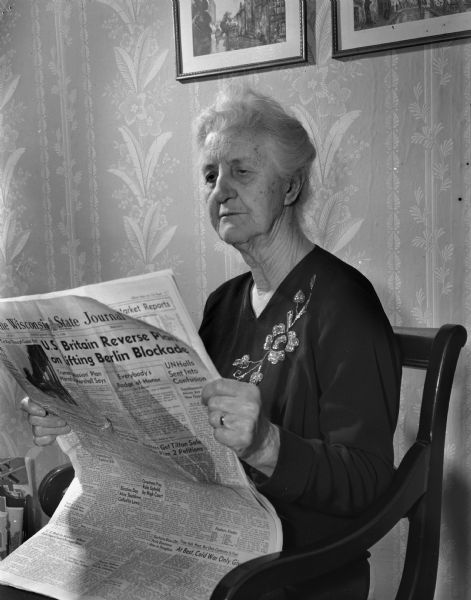 Eighty-five-year-old Mrs. C.A. Green, reading the <i>Wisconsin State Journal</i> during a stay with her daughter and son-in-law, Mr. and Mrs. Glen C. (Florence) Hogoboom. She is a resident of Onawa, Iowa. She claims to be a rabid Republican and follows all the campaign news.
