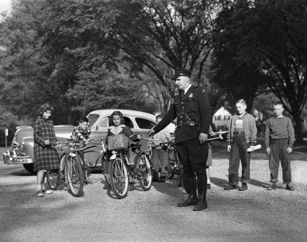 Maple Bluff police officer A.J. Taft, with Lakewood School children with their bicycles.