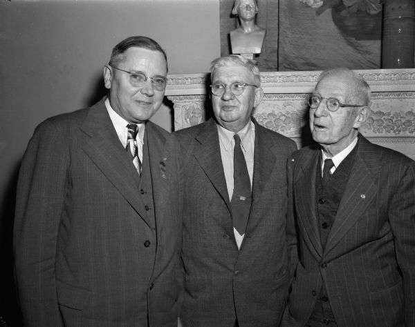 Three members of the Madison Consistory at a reunion of Masons at the Masonic Temple. Left to right: Walter Strong, First Lieutenant commander of the consistory; Roy R. Wheeler, custodian; and John G. MacFarlane, dramatic director of consistory casts.