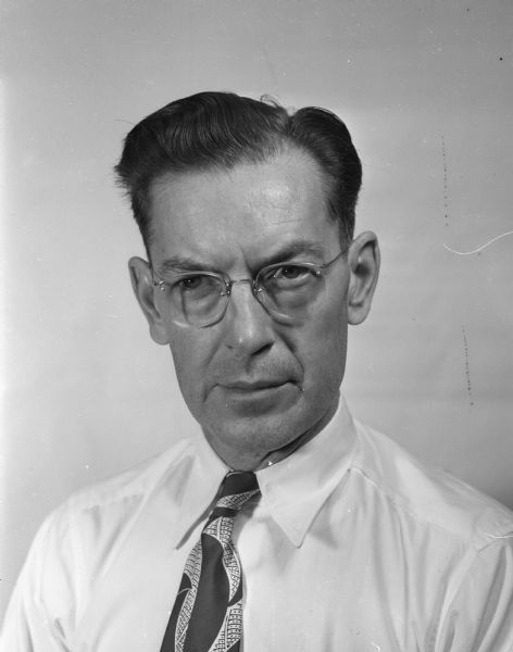 Head and shoulders portrait of Ed Hickey, who bowled Madison's second national honor count of the season with games of 260, 213, and 233. Mr. Hickey, who bowls with the Badger League at the Moderne Recreation Alleys, is a federal government employee of the Madison Post Office.