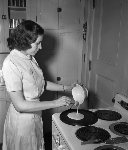 University of Wisconsin home economics student Charlene Bishop, making pancakes in a laboratory.