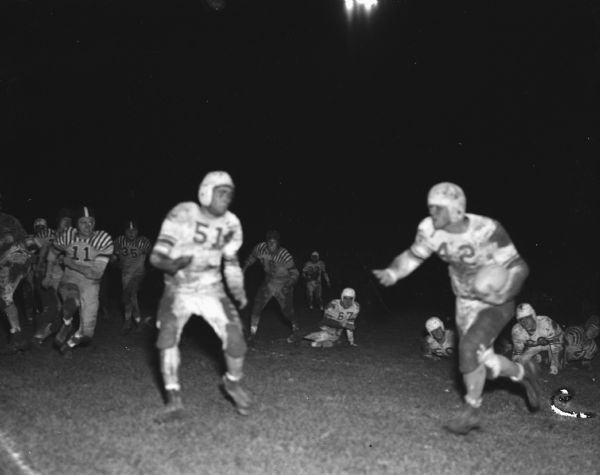 Action shot of the Madison East and Beloit high school football teams during their night game.