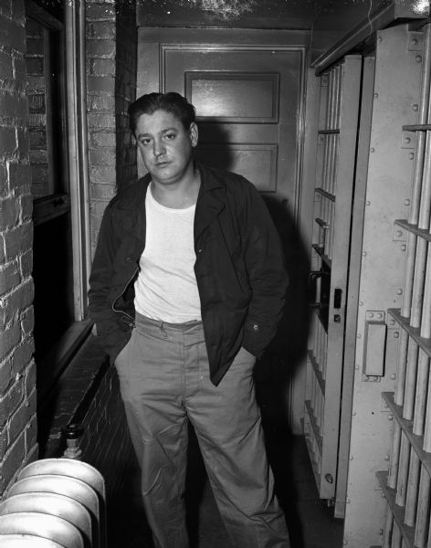 John Vasas, Milwaukee, arrested after he robbed the Fiore Coal and Oil Company Filling Station, 601 West Washington Avenue. He is standing in the hallway of the county jail.
