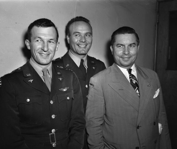 Capt. Homer P. Anderson, U.S. Air Force, (center) posing at a meeting of the Kiwanis club at the Park Hotel. With him are his co-pilot from Langley Field in Virginia, William M. Mettler. (left) and Edward J. Konkol, a member of Kiwanis and a director of the Wisconsin Civil Air Corps. Capt. Anderson spoke of the rigid qualifications that must be met by the pilots who fly a minimum of 4,500 tons of food and supplies into Berlin each day via the allied airlift.
