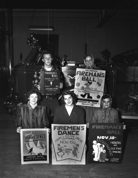 Group portrait of the winners of the Madison Fire Fighters union poster contest, held in conjunction with the annual Firemen's ball. Left to right in the front row: Marian Hill, East High, winner of the $10 first prize; Gula Mae Trummer, West High, winner of the $8 second prize; and Judy Matthews, West High, winner of the $5 third prize. Left to right at the rear: Ted Anderson, Central, who won $4 for fourth prize; and Jackie Fisher, West High, winner of the $2 fifth prize.