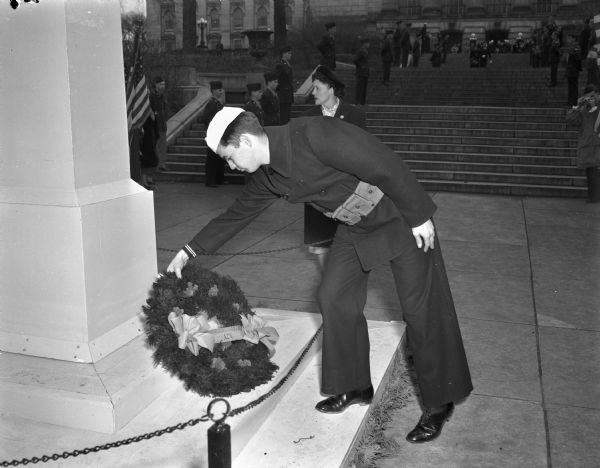 Robert Babcock, Lodi, places the American Legion auxiliary post Number 57 memorial wreath at the front of the memorial obelisk on the grounds of the Wisconsin State Capitol during Armistice Day commemoration ceremonies.