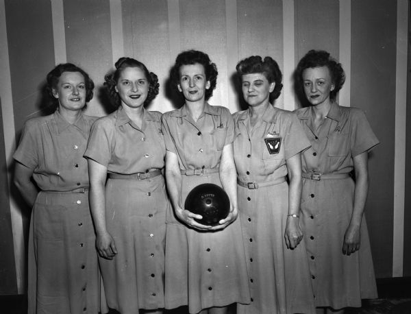 Group portrait of the Cleveland Lunch women's bowling team, winners of the Class A title of the city tournament of the Madison Woman's Bowling Association. Members of the team, left to right: Marian Callahan, Gladys Iotte, Corky Slotten, Dorothy Sutton, and Adeline Colvin.