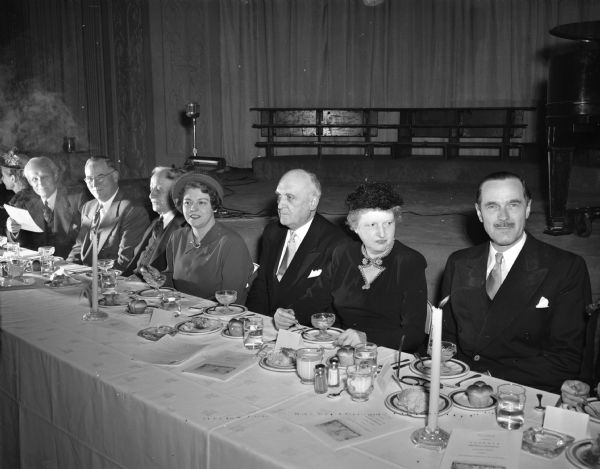 Guests of honor at the banquet that opened Dane county's campaign for the University of Wisconsin centennial campaign. From the left are: Prof. Kiekhofer; Dean John Guy Fowlkes; Frank Sensenbrenner, president of the board of regents; Mrs. Fowlkes; Pres. Edwin B. Fred; Mrs. Fred; and Don Anderson, publisher of the <i>Wisconsin State Journal</i> and chairman of the Dane County drive.