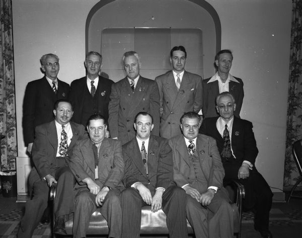 National officials who attended the Mid-West and Mid-Northwest convention of the "700" Clubs of America in Madison. Front row, left to right, are Charles Allen, grand foul judge, Madison chapter; Buck Wittenberg, La Crosse; Charles Carey, grand king pin, Madison chapter; Bruno Yamatas, national grand foul judge, Rockford, Illinois; and Ferd Lipovetz, grand pin buoy and originator of the national organization, La Crosse. Back row, left to right, are Harry Baxter, La Crosse; Bill Blau, national grand rex honoree, Madison; Willard Harlam, national grand king pin, Negaunee, Michigan; Arnold Stapleton, Northwest grand prince pin, Peoria, Illinois; and Ed Goettsch, national grand prince pin, Clinton, Iowa.