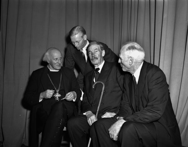 British Clergyman and others gathered before the address of The Very Reverend Hewlett Johnson, Dean of Canterbury, shown on the left. Others, left to right are: Reverend Edwin A. Gaede, pastor of Pilgrim Congregational Church; Emeritus Professor E.A. Ross, and the Reverend George Collins, pastor of the Baptist student center.