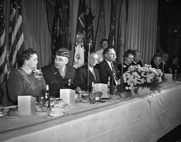 At a VFW banquet, Lyall T. Beggs, national commander of the Veterans of Foreign Wars, was honored by the VFW and Madison citizens at the Hotel Loraine in the Crystal Ballroom. Pictured, left to right, at the head table: Helen M. Murphy, national auxiliary president of the VFW; Commander Beggs; Joseph Rothschild, toastmaster; Colonel Omar Ketchum, national legislative director of the VFW; Mrs. (Christine) Beggs, and Justice Edward T. Fairchild of the supreme court.