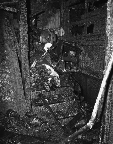Charred remains of the open stairway, which was the closest means of escape for the families who lived upstairs at the rear of the building at 15 South Bedford Street. The structure is a tenement-type house at the rear of the city garage. The fire killed Florence Dinger and three of her children
