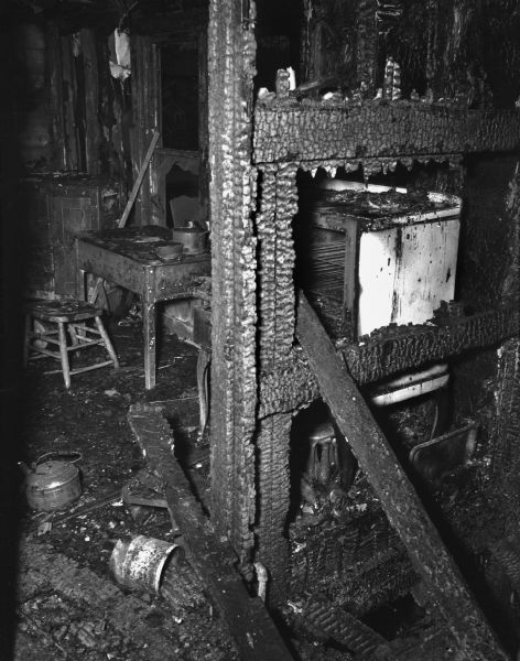 Fire-charred apartment of Annie Simmons and her four children, at the rear of the tiny bedroom in which Florence Dinger and her three children died.