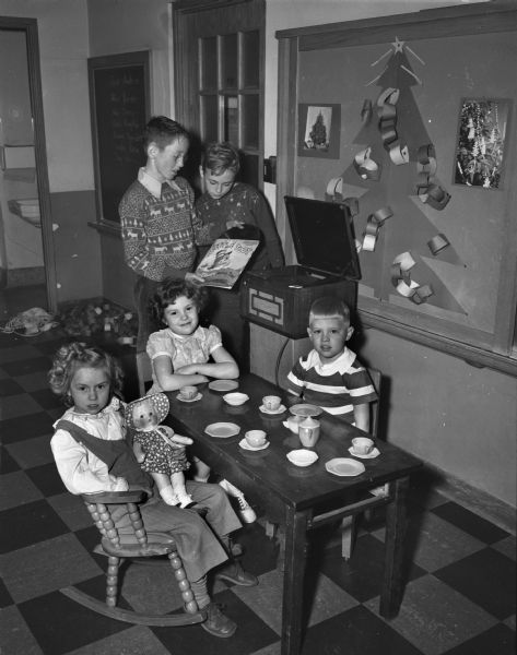 Gifts of dishes, radio-phonograph, wire recorder, toys and books are enjoyed by children at Lapham School. Roundy's Fun Fund provided these and more items for the benefit of children.