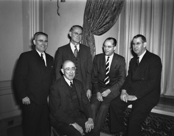 Five men attending the annual meeting of the National Council of Chief State School Officers. Left to right: standing, E.B. Norton, executive secretary of the council; R.L. Grigsby, Washington, D.C., acting commissioner of the U.S. Office of Education; Edgar Fuller, director of School Administration in the federal office; and Clyde A. Erwin, North Carolina State Superintendent of Public Instruction. Seated is John H. Bosshart, Trenton New Jersey, council president.