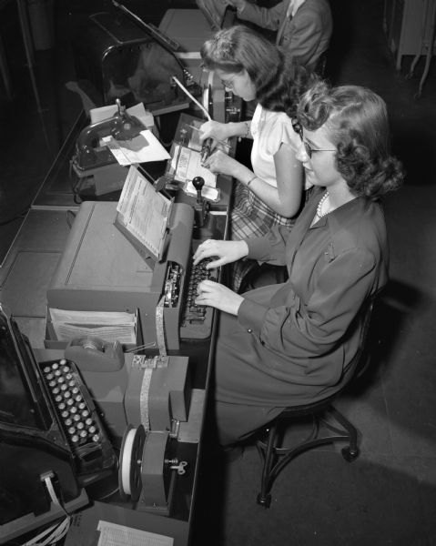 Geraldine Sommer, foreground, and Frances Zeier, two operators in the Madison office who have been trained to operate transmitting machines for the new speedy telegraph service which went into service.