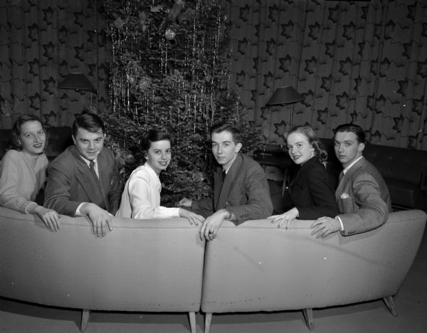 Six committee members planning a Christmas Ball for university students and the "young married." Left to right: Margot Schmidt; Toby Sherry; Kathleen Kellog, committee co-chair; George Rayne; Sherry Crownhart; and Thomas Hefty, committee co-chair.