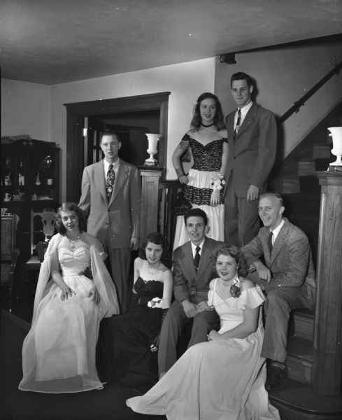 Betty Oxnem, daughter of Mr. and Mrs. Russel Oxnem of 10 Vista Road, shown with a group of friends she entertained at an "open house" prior to the Theta Phi Alpha Christmas formal dance. Seated, (left to right) are Mary Jane Mulrooney, Anne Nienaber, Fred Knapp, Miss Oxnem, and Gordon Goetzl. Standing, (left to right) are Michael Kycia, Carolina Leer, and Eugene St. Ores.
