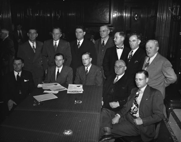 Wisconsin's twelve Democratic electors met at the Wisconsin State Capitol to cast the state's electoral votes for President Truman and Vice-President Barkley. Left to right, seated, are: Arthur L. Henning, Altoona; Attorney General Thomas E. Fairchild, chairman of the group; Carl W. Thompson, Stoughton; William D. Carroll, Prairie du Chien, and Arnold J. Miller, Portage, named in place of Charles W. Henney, Portage.
Standing, left to right: Senator Anthony Gawronski, Milwaukee; Arthur Gruenwald, Oshkosh; Clayton Crooks, Wausau; John Mierzejewski, West Allis; Elmer ?, Kenosha; George Meyers, Medford, and William C. Sullivan, Kaukauna.