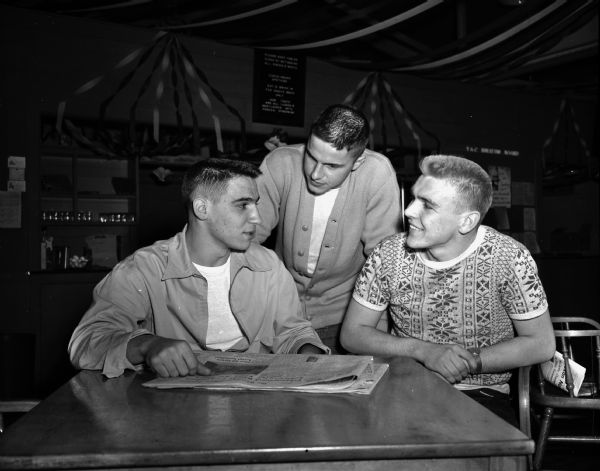 Three Madison high school football players, named to the 1948 Wisconsin All-Star football team. Left to right: Peter Cuilla and Al Trotalli, West High School, and Jim Waters of Central High School.