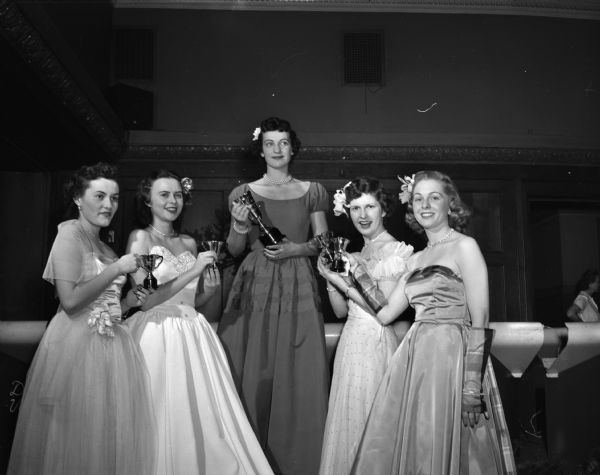 The Phi Delta Theta "Dream Girl" of the year, with her court at the fraternity's Christmas formal at the Park Hotel. The "Dream Girl" is Betty Burt of Dallas Texas. In the court of honor are, left to right: Joan Ellis, Maple Bluff; Joan Henderson, Edgerton; Nancey Krueger, Neenah; and Janell Goldgruber, Madison.