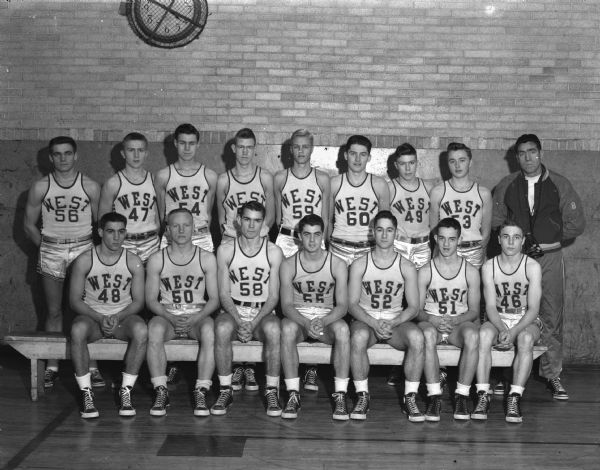 The West High School basketball team will take part in a holiday double-header at the field house. 
The players are shown left to right: first row, Peter Cuilla, Dick Christenson, Keith Johnson, Dale ?, Jim Critton, Jack Vincent, Jim Clapp.
Second row: Art Schulz, Evert Allenfeld, Phil ?, Duane Bredeson, John ?, Robert Lea, Jack Mansfield, Mort Huber, and Coach Bob Harris.
