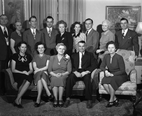 A group portrait of Mrs. David M. Fowler (mother of Mrs. Mary Rennebohm), with seven of her eight children and their spouses. The children are: Mr. and Mrs. David M. Fowler II, Mona, Utah; Mr. and Mrs. Phillip E. Anderson, Indianapolis, Indiana; Mr. and Mrs. Morton L. Fowler, Armstrong, Illinois; Mr. and Mrs. Henry B. Saunders, Oak Park, Illinois; Mr. and Mrs. William J. Fowler, Sandwich, Illinois; and Mr. and Mrs. Charles R. Fowler, St. Joseph, Michigan.