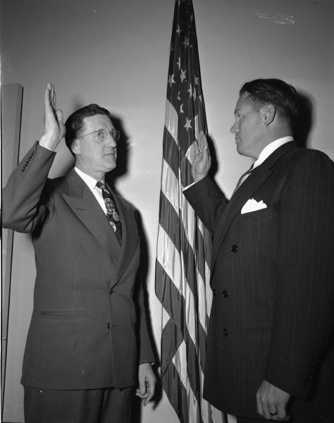 City Clerk Alfred W. Bareis swears in police chief Bruce Weatherly. Alfred W. Bareis was mayor from 1955-1956.