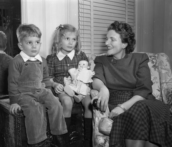 Mrs. Nelson (Marjori) Hagan and her two children, Jessica, 5, and Nelson Jr. "Kip," 3, in the home of Mr. Hagan's mother, Mrs. Milo C. Hagan, 153 East Gilman Street. The Hagans, who recently moved to the area from Atlanta, Georgia, have purchased a home in Shorewood Hills.