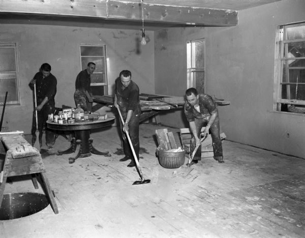 Fire fighters at Fire Station No. 4 working to convert the old hayloft at the station into a utility room. From left are fire fighters Fred Rice, Maurice Nason, Wilson Donkle, and Joe Tisserand.