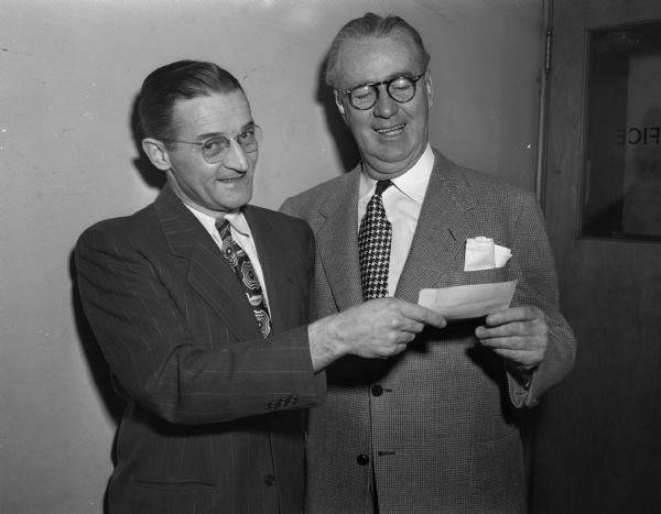 Roundy Coughlin, right, turning over to Bernard Gill, secretary of Roundy's Fun Fund, a check for $4,000.25. This money is used for the handicapped children at Washington Orthopedic school, Wisconsin Orthopedic Hospital, Rheumatic Fever Home, and Camp Wawbeek.