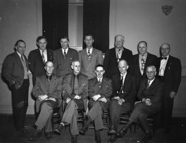 Group portrait of twelve electricians with twenty-five years of service.