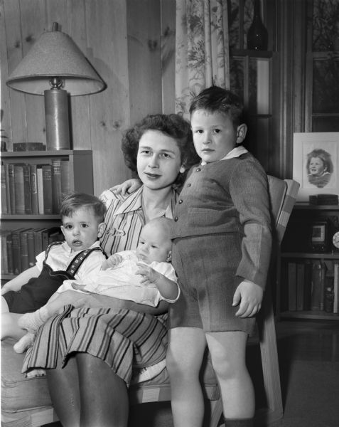 Portrait of Mrs. Richard W. (Elizabeth) Bardwell Jr. and her three children. Left to right: Steven, 18 months; Norda Elizabeth, 3 months, and Richard III, five. The family recently moved from Milwaukee to Madison where Mr. Bardwell is a member of the law firm of Arthur and Bardwell.