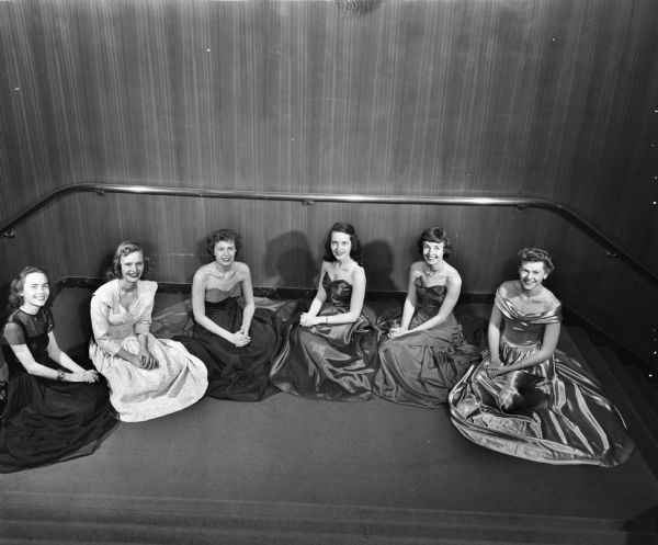 Elevated view of the court of honor for the University of Wisconsin Junior Prom. The coeds, from left, are: Jeannine Forsmo, Wausau; Gay Phillipson, Kenosha; Janet Williams, Kenilworth, Illinois; Shirley Kretche, Manitowoc; Margaret Tanner, Eau Claire; and Barbara Talley, Wilmette, Illinois.