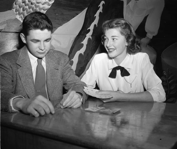 Walter Meanwell and his date, Mary Ann Pohle, playing gin rummy on a date. They both live in Shorewood Hills and attend Wisconsin High School.