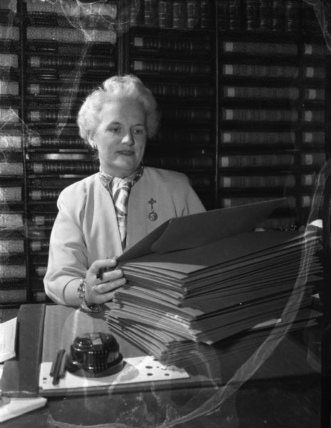 Dane County Clerk of Circuit Court Myrtle Hansen in her office with some of the court orders from 1948 which permitted about 50 Madison residents to change their names.