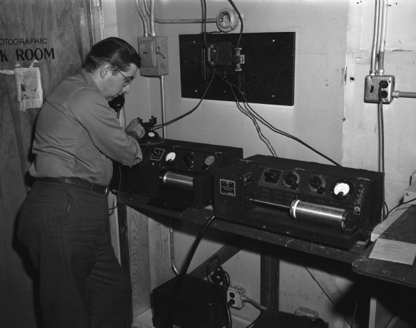 In the newsroom of the "Wisconsin State Journal," an employee with the newly acquired Associated Press wire photo sending and receiving machine.